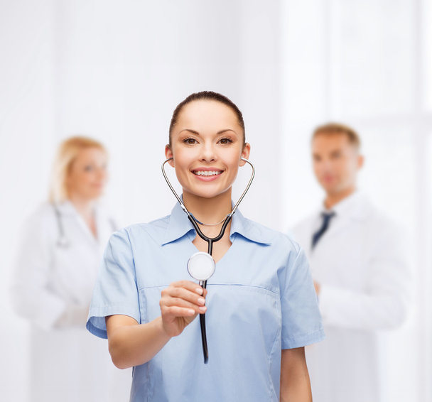 Smiling female doctor or nurse with stethoscope - Fotó, kép