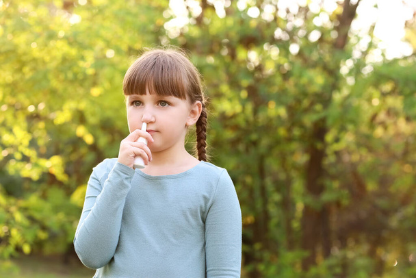 Μικρή αλλεργική κοπέλα με ρινικές σταγόνες σε εξωτερικούς χώρους - Φωτογραφία, εικόνα