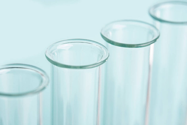 Macro laboratory glass test tubes over blue background - Photo, Image