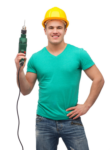 Smiling manual worker in helmet with drill machine - Photo, Image