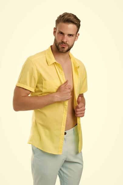 confident in his sexuality. sexy guy undressing. seducing you. unshaven macho unbuttoned shirt. Casually handsome. Fashion portrait of young man. morning male grooming. summer and spring collection - Φωτογραφία, εικόνα