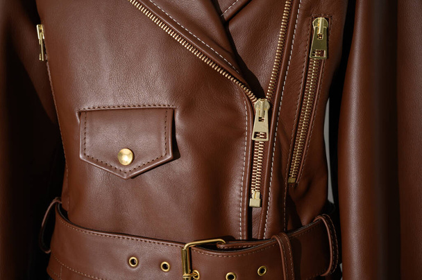 Brown leather jacket with metal zippers on it. Stitched leather. Closeup. Horizontal fashion background. - Photo, Image