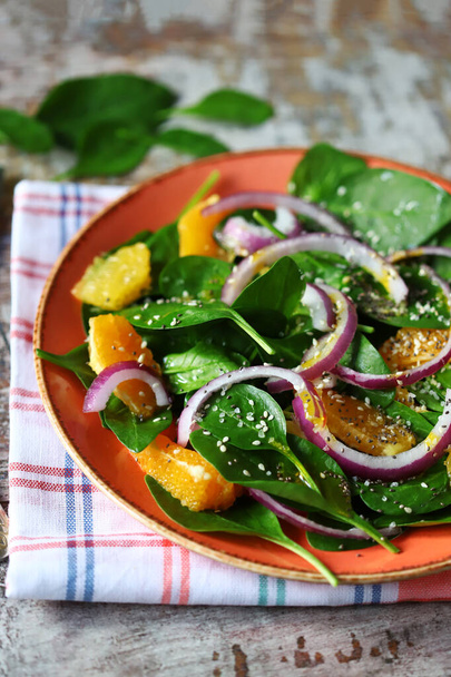 Plate with salad. Green fresh detox salad with spinach and orange. Healthy food concept. Super food. - Photo, Image