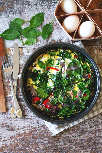 Spinach omelet in a pan. Cooking healthy food at home. - Photo, Image