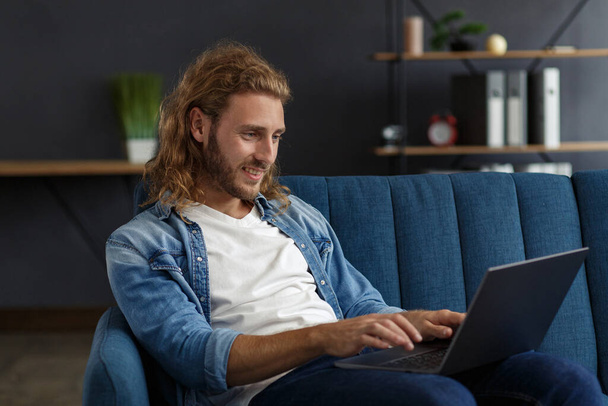 Young freelancer working in home with laptop. Texting messages, browsing internet. Studying online, online education, remote working. Young people working at home. Business concept. - Foto, Imagem
