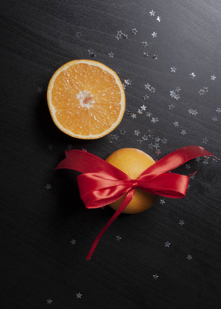 oranges with glitter stars on black background - Photo, image