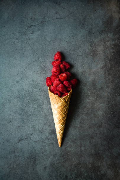 Fresh berries in waffle cone on dark stone background, top view. Concept healthy food and desert. - Φωτογραφία, εικόνα