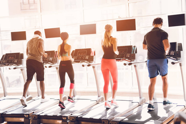 People athletes on treadmills run together - Photo, image