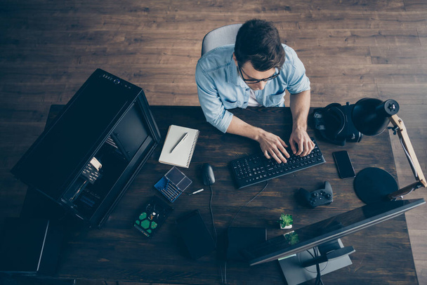 Top above high angle view of his he nice focused guy geek expert specialist typing e-commerce project start-up innovation security data at modern wooden industrial office workplace workstation - Foto, imagen