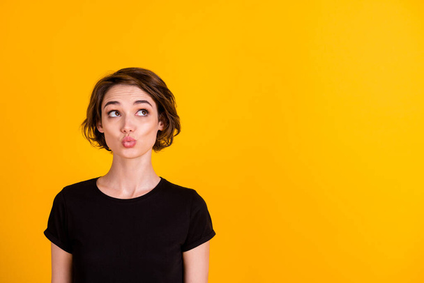 Close-up portrait of charming curious flirty girl thinking copy space pout lips isolated over bright yellow color background - Fotografie, Obrázek