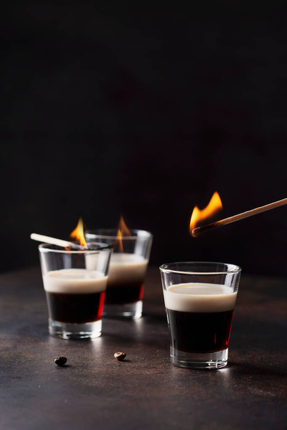 Bar concept. Coffee ligueur wit irish cream ready to set fire, selective focus image - Фото, изображение