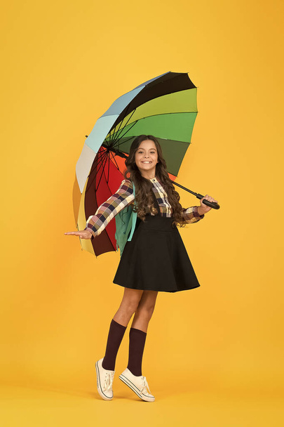 Schoolgirl daily life. Girl with umbrella. Rainy day. Happy childhood. Kid happy schoolgirl with umbrella. Fall weather forecast. Rainy september. Towards knowledge. Schoolgirl with backpack - Photo, image