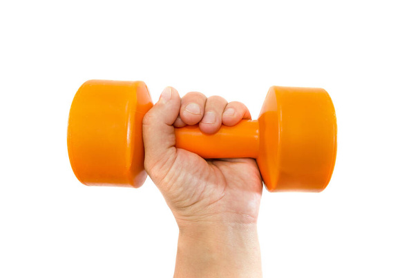 orange dumbbell in a female hand on a white background. - Photo, Image