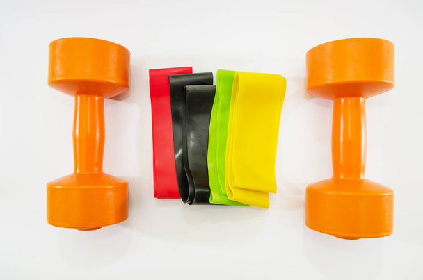 dumbbells and elastic bands for fitness on a white background. - Photo, Image