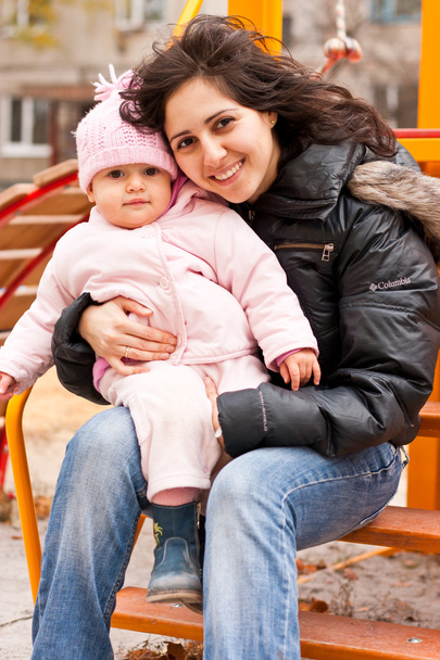 Mother and daughter outdoor on a playground - Foto, immagini