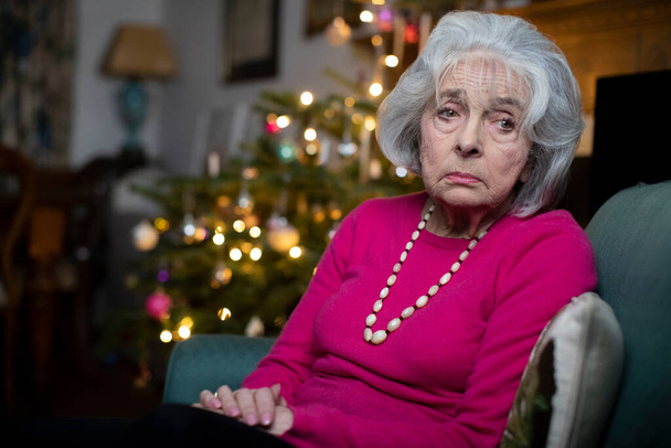 Sad And Lonely Senior Woman Unhappy About Spending Christmas At Home Alone - Photo, Image