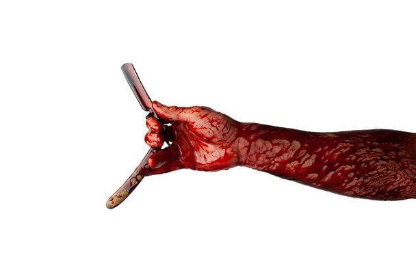 Bloody hand with straight razor isolated on white background. - Photo, Image