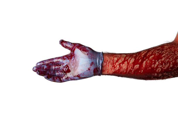 Bloody hand in medical gloves isolated on white background. - Photo, Image