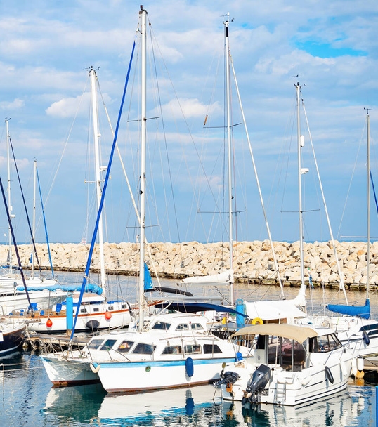 Seascape with clouds over marina with yachts, stone pier in background, Larnaca, Cyprus - 写真・画像