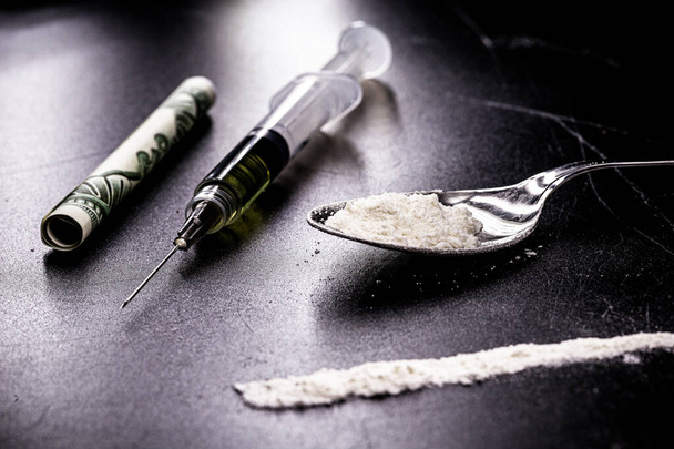 dope, narcotics, illegal drugs on dark black background. Heroin syringe, pills, cocaine. - Foto, Imagem