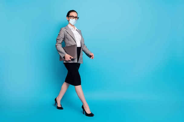 Full length photo of nice lady leader carrying laptop going on meeting wear mask isolated on bright blue color background - Photo, image
