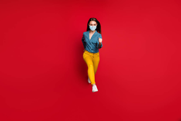 Full length body size view of lovely thin girl jumping running motion wear mask isolated on bright red color background - Photo, Image
