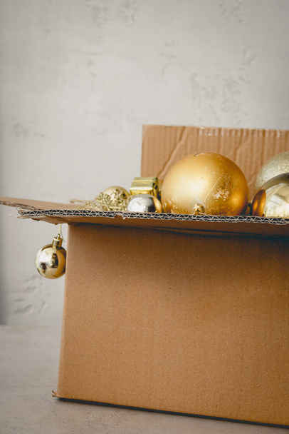 Unpacking Cardboard Box with New Year Toys Golden Balls Christmas Concept - 写真・画像