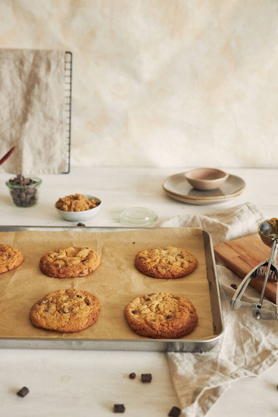 A vertical shot of delicious chocolate chips cookies on an oven tray - 写真・画像