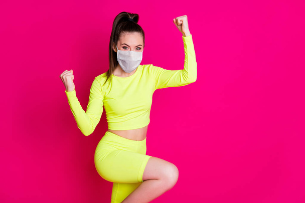 Profile photo of astonished lady stand fists up dress respiratory sport suit isolated on vibrant shine pink color background - Φωτογραφία, εικόνα