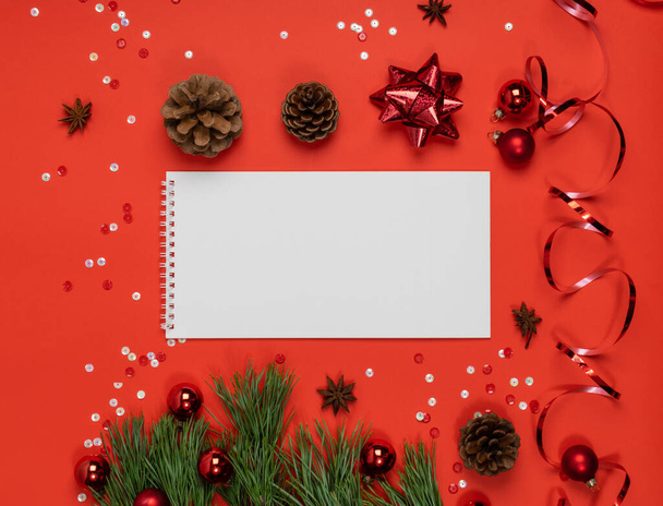 Christmas Decorations Mockup with White Horizontal Notepad Top View. Red Xmas Background with Copy Space - Photo, Image