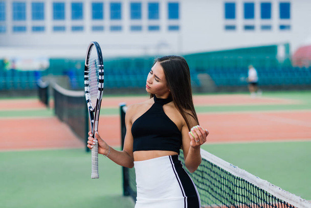 Beautiful stylish sexy woman in a trendy sportswear on tennis court. - Foto, Bild
