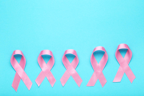 Cancer concept. Pink ribbons on blue background - 写真・画像