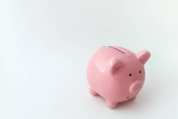 Piggy bank in the shape of a pig on an isolated white background - Foto, Bild