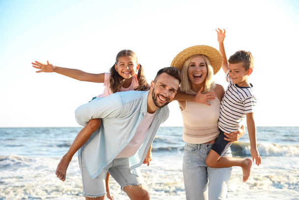 Happy family on beach near sea. Summer vacation - Fotografie, Obrázek