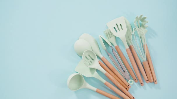 Flat lay. New blue silicone kitchen utensils with wooden handles   - Footage, Video