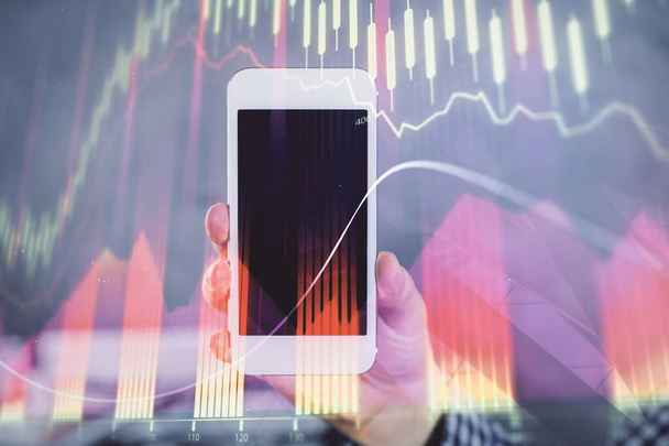Double exposure of mans hands holding and using a digital device and forex graph drawing. Financial market concept. - Фото, зображення