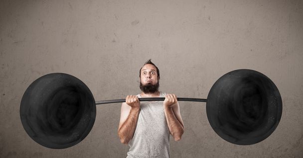 Funny skinny guy lifting weights - Фото, изображение