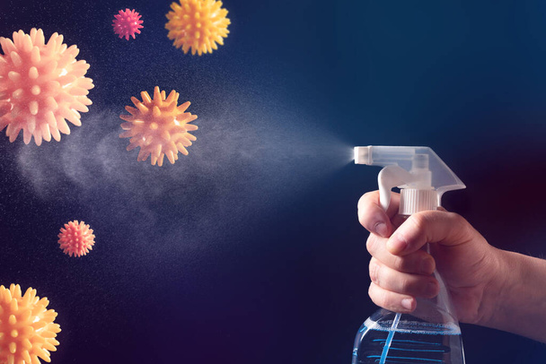 Hand with a spray bottle on a dark background. A spray of water. Antibacterial gel for hand disinfection. Cleaning. Covid-19 coronavirus - Fotó, kép