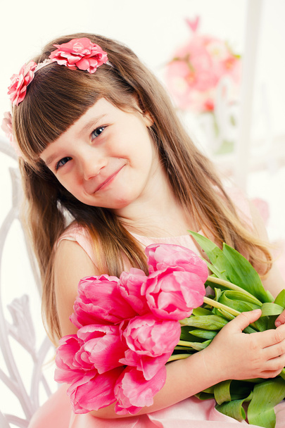 Adorable little girl with bouquet of tulips - Photo, image