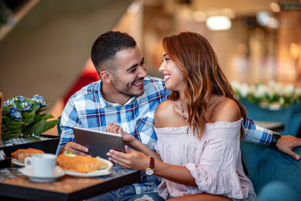 Attractive young couple in love having breakfast in cafe. - Fotoğraf, Görsel