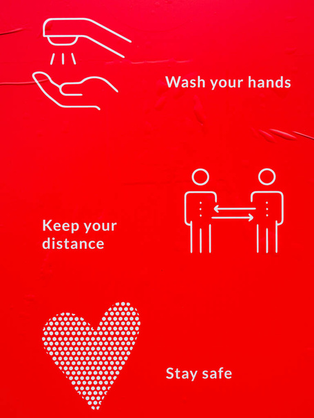 View on covid-19 protection instruction on a red background - Photo, Image