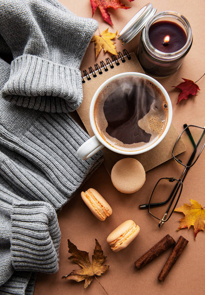 Beautiful and romantic autumn composition with  cup of coffee, warm blanket, decorative striped pumpkins, candles and autumn leaves. Cozy morning. Hygge home interior. - Photo, Image