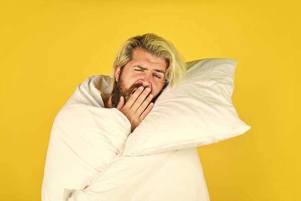yawning male. bearded guy wear white blanket sleeping at hotel bedroom. bed rest while sick. man in underwear. Man wrapped in blanket the bathroom. handsome man in the morning - Fotoğraf, Görsel