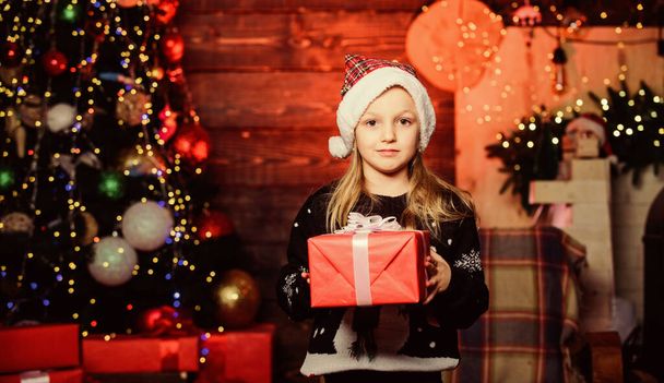 Merry Christmas and happy new year. Small child getting present on Christmas day. Adorable kid with beautifully wrapped Christmas gift. Happy little girl holding Christmas present from Santa - Photo, image