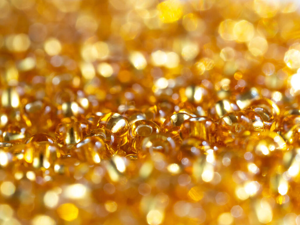 Background with tiny golden beads, shiny, glittering - Фото, изображение