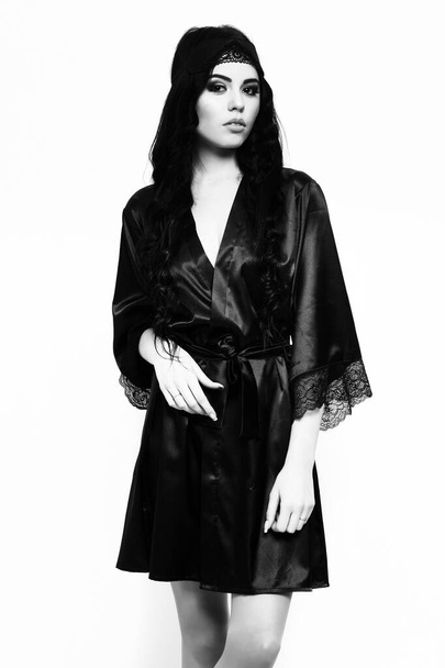 sexy girl posing in black silk robe isolated on white - 写真・画像