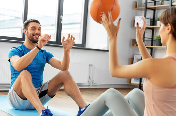 happy couple exercising with ball at home - Photo, Image
