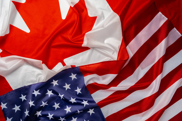 Flags of Canada and USA folded together - 写真・画像