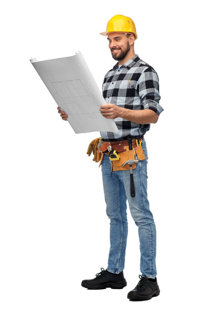 male worker or builder in helmet with blueprint - Фото, изображение