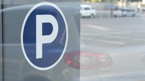 Parking lot sign as symbol of traffic difficulties and transportation issues in busy urban areas of USA. Public paid parking zone in downtown of San Diego, California. Limited space for cars in city - Footage, Video